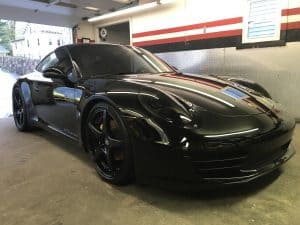 detailed black porsche 911 inside difiore's detailing garage