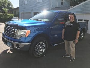 blue ford f-150 with owner
