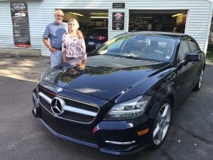 Black Mercedes outside of difiore details garage with owners standing next to it