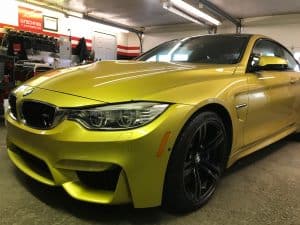 yellow bmw parked inside the difiore's detail garage