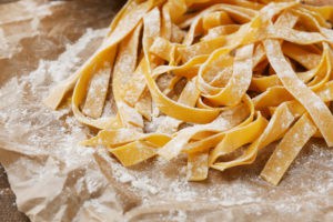 Still life with raw homemade pasta and ingredients for pasta