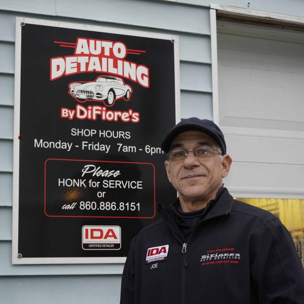 joe difiore of difiores detail standing next to his business sign